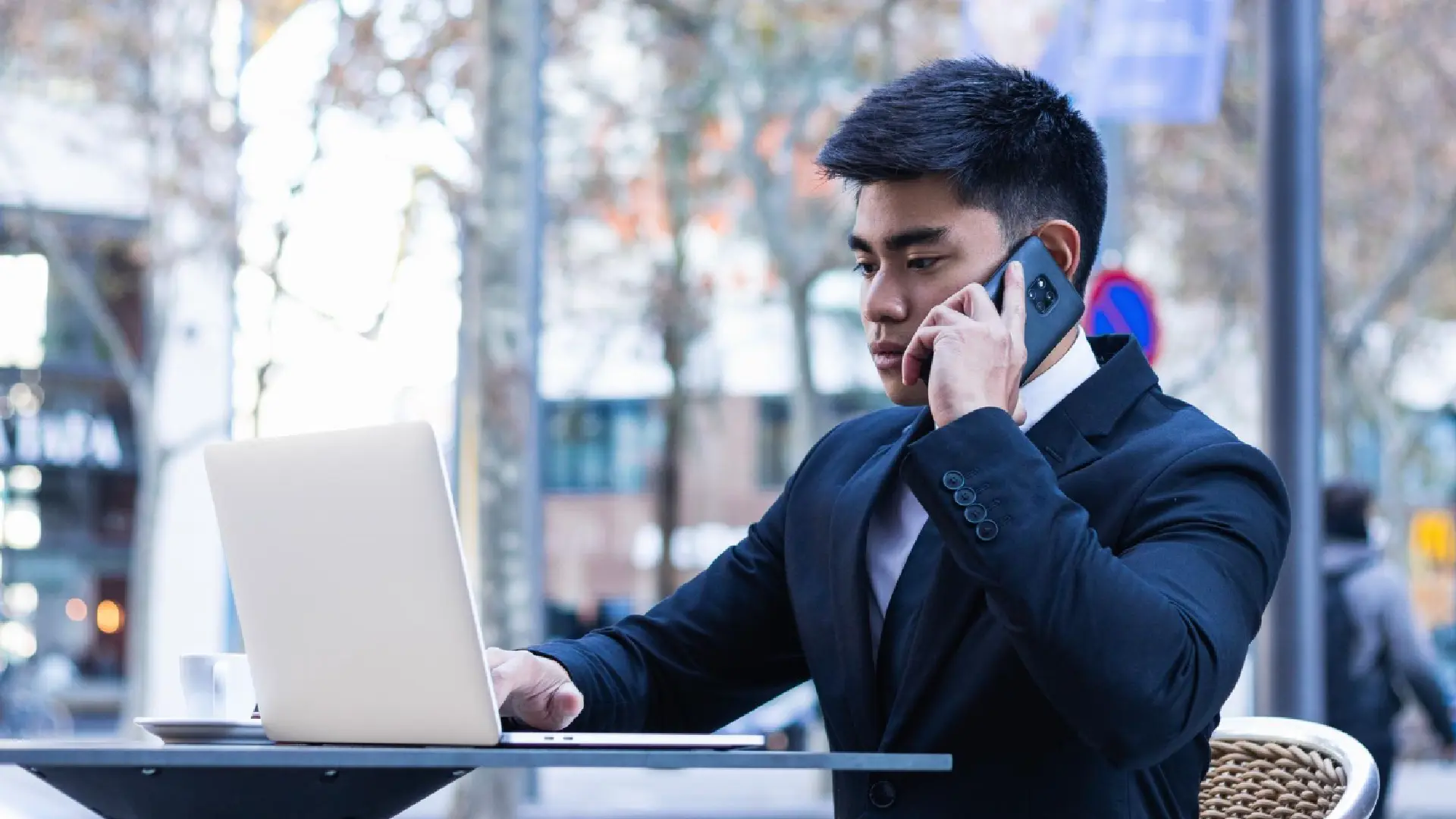 Businessman on a cold call from his laptop, representing PDPA Do Not Call Registry compliance for Singapore businesses