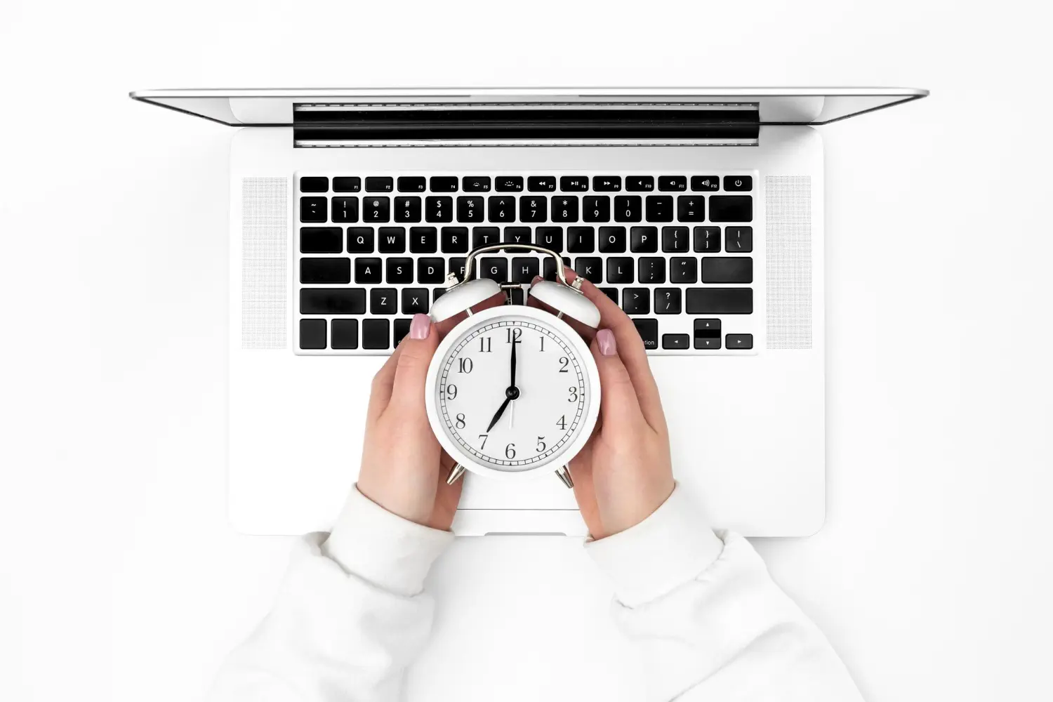 3x-faster-follow-up-ai-cold-leads-singapore Alarm clock held over a laptop keyboard, representing faster AI follow-up on cold leads